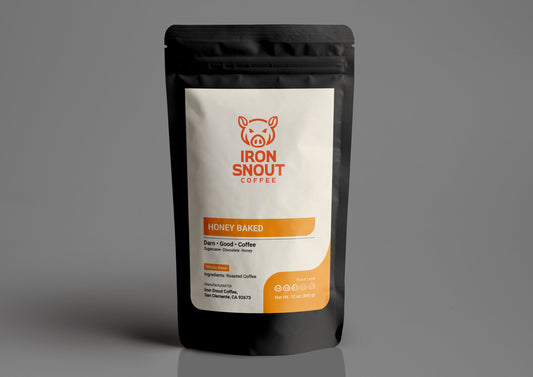 The black resealable coffee bag, labeled "Iron Snout Coffee," features a pig logo and highlights the honey-baked coffee flavor..